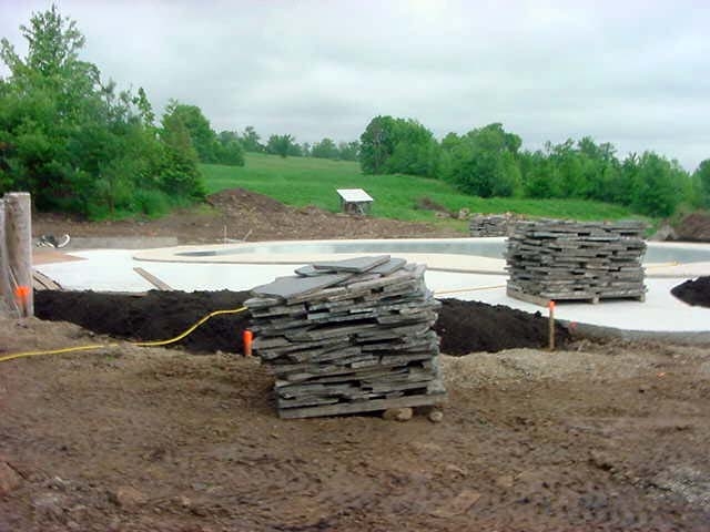 flag stone was layed round the pool on a bed of concrete